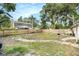 Backyard featuring a grill, patio, and sturdy fencing, all shaded by mature trees at 6024 90Th N Ave, Pinellas Park, FL 33782