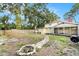 The expansive yard boasts a fire pit, screened porch, sturdy fencing, and mature shade trees at 6024 90Th N Ave, Pinellas Park, FL 33782