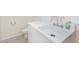 Bright bathroom featuring a white sink and cabinet with a toilet at 6024 90Th N Ave, Pinellas Park, FL 33782
