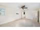 Well-lit bedroom with tile flooring, ceiling fan, and access to a closet and bathroom at 6024 90Th N Ave, Pinellas Park, FL 33782