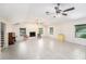 A large living room with tile flooring, a fireplace, and multiple ceiling fans at 6024 90Th N Ave, Pinellas Park, FL 33782