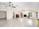 Large living room featuring tile flooring, a fireplace, and ceiling fans for added comfort at 6024 90Th N Ave, Pinellas Park, FL 33782