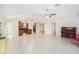 View of the living room and kitchen, featuring tile floors and ceiling fans at 6024 90Th N Ave, Pinellas Park, FL 33782