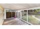 Outdoor screened porch with wood deck and view of the fenced backyard at 6024 90Th N Ave, Pinellas Park, FL 33782