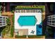 Aerial view of a sparkling blue swimming pool and manicured landscaping at 6100 Gulfport S Blvd # 114, Gulfport, FL 33707