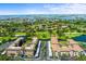 Stunning aerial view of condos overlooking a golf course, lakes, and the ocean at 6100 Gulfport S Blvd # 114, Gulfport, FL 33707