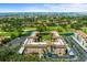 Elevated view showcases the community near a golf course, pond, and Tampa Bay at 6100 Gulfport S Blvd # 114, Gulfport, FL 33707
