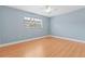 Comfortable bedroom with laminate floors, ceiling fan, and ample natural light at 6100 Gulfport S Blvd # 114, Gulfport, FL 33707