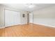 Bedroom featuring wood-look flooring, large closet, neutral paint, and a ceiling fan at 6100 Gulfport S Blvd # 114, Gulfport, FL 33707