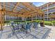 Outdoor seating area with mature landscaping and shade trellis in a beautiful courtyard at 6100 Gulfport S Blvd # 114, Gulfport, FL 33707
