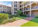 Well-manicured courtyard with brick paths and lush green spaces in a condominium community at 6100 Gulfport S Blvd # 114, Gulfport, FL 33707