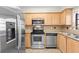 Kitchen with stainless steel appliances, including a microwave, and tile countertops at 6100 Gulfport S Blvd # 114, Gulfport, FL 33707