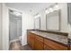 Well-lit bathroom featuring granite counters, dual mirrors, and a separate shower room for added convenience at 6322 Palma Del Mar Blvd S # 604, St Petersburg, FL 33715