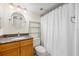 Clean bathroom with a vanity featuring granite counters, a round mirror, and a shower with curtain at 6322 Palma Del Mar Blvd S # 604, St Petersburg, FL 33715