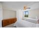 Cozy bedroom features twin beds and a dresser, with natural light filtering in from the window at 6322 Palma Del Mar Blvd S # 604, St Petersburg, FL 33715
