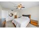 Cozy bedroom with a comfortable bed, ceiling fan, and a view into an en-suite bathroom with a round mirror at 6322 Palma Del Mar Blvd S # 604, St Petersburg, FL 33715