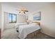 Bright bedroom featuring twin beds, soft artwork, and a large window offering natural light and neighborhood views at 6322 Palma Del Mar Blvd S # 604, St Petersburg, FL 33715