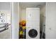 Convenient laundry area with stacked washer and dryer units, plus shelving for storage and ironing board at 6322 Palma Del Mar Blvd S # 604, St Petersburg, FL 33715