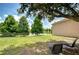 A fenced backyard offers a tranquil view of the pond, shaded by mature trees, creating a serene retreat at 6519 Twin Bridges Dr, Zephyrhills, FL 33541