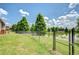 Scenic backyard with a lake view, black fence, and lush green lawn, perfect for relaxation at 6519 Twin Bridges Dr, Zephyrhills, FL 33541