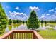 Picturesque backyard view with a tranquil lake, mature trees, and lush green lawn at 6519 Twin Bridges Dr, Zephyrhills, FL 33541