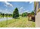 Lush backyard view featuring a serene lake, mature trees, and a wooden deck for relaxation at 6519 Twin Bridges Dr, Zephyrhills, FL 33541