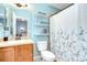 Bright bathroom with blue walls, a vanity, and a shower/tub combination, offering a clean and functional space at 6519 Twin Bridges Dr, Zephyrhills, FL 33541