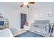 Bedroom with a crib, soft rug, comfortable chair and neutral décor, creating a peaceful and inviting space at 6519 Twin Bridges Dr, Zephyrhills, FL 33541