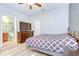 Light filled bedroom with a TV and dresser, offering a comfortable and relaxing space at 6519 Twin Bridges Dr, Zephyrhills, FL 33541