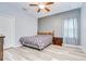 Cozy bedroom with hardwood floors, a ceiling fan, neutral colors and a view of the backyard at 6519 Twin Bridges Dr, Zephyrhills, FL 33541
