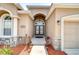 Grand entryway boasting a double-door entry, stone accents, and a welcoming pathway at 6519 Twin Bridges Dr, Zephyrhills, FL 33541