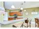 Charming kitchen with breakfast bar, pendant lights and ample cabinet space at 6519 Twin Bridges Dr, Zephyrhills, FL 33541
