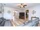 Open-concept living room with hardwood floors, modern decor, and seamless flow into kitchen at 6519 Twin Bridges Dr, Zephyrhills, FL 33541