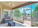 Relaxing screened porch with lake view, ceiling fan, and comfortable outdoor furniture at 6519 Twin Bridges Dr, Zephyrhills, FL 33541