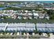 A beautiful aerial view of waterfront townhomes with boat docks and easy access to the bay and beaches at 659 Garland Cir, Indian Rocks Beach, FL 33785