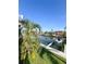 Waterfront backyard featuring a boat lift and dock, perfect for boating enthusiasts and outdoor living at 659 Garland Cir, Indian Rocks Beach, FL 33785