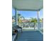 Relax on this covered balcony, perfect for enjoying the waterfront view and tranquil surroundings at 659 Garland Cir, Indian Rocks Beach, FL 33785