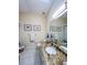 Bathroom featuring a granite vanity with a white sink, a decorative mirror and overhead lighting at 659 Garland Cir, Indian Rocks Beach, FL 33785
