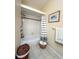 Cozy bathroom featuring a shower-tub combination with tiled walls and decorative accents at 659 Garland Cir, Indian Rocks Beach, FL 33785