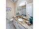 Bright bathroom with granite countertops, a stylish mirror, and coastal-themed decor at 659 Garland Cir, Indian Rocks Beach, FL 33785