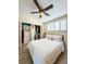 Comfortable bedroom featuring a ceiling fan, shuttered windows and a closet with a wardrobe organizer at 659 Garland Cir, Indian Rocks Beach, FL 33785
