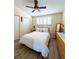 Comfortable bedroom featuring a ceiling fan, shuttered windows, and double-door closets at 659 Garland Cir, Indian Rocks Beach, FL 33785