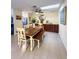 Dining room with wooden table and bench seating, modern decor, and a view of the kitchen at 659 Garland Cir, Indian Rocks Beach, FL 33785