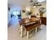 Dining room with wooden table and bench seating, modern decor, and access to the kitchen and living areas at 659 Garland Cir, Indian Rocks Beach, FL 33785