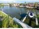 A private dock with a boat lift on a serene canal leads to the Gulf, providing deep water access at 659 Garland Cir, Indian Rocks Beach, FL 33785