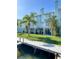 Waterfront condos with private docks on lush lawn overlooking the water and blue sky at 659 Garland Cir, Indian Rocks Beach, FL 33785