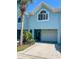 Charming two-story townhome features a one car garage, lovely front yard, and is move-in ready at 659 Garland Cir, Indian Rocks Beach, FL 33785