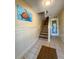 Inviting hallway featuring tiled floors, staircase, and a coastal-themed turtle artwork at 659 Garland Cir, Indian Rocks Beach, FL 33785