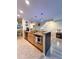 Open kitchen island with granite countertops, stainless appliances, and stylish pendant lighting at 659 Garland Cir, Indian Rocks Beach, FL 33785