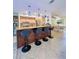 Eat-in kitchen featuring a breakfast bar, stainless steel appliances, granite countertops, and wood cabinets at 659 Garland Cir, Indian Rocks Beach, FL 33785